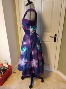 the galaxy dress from the left side on a dress form