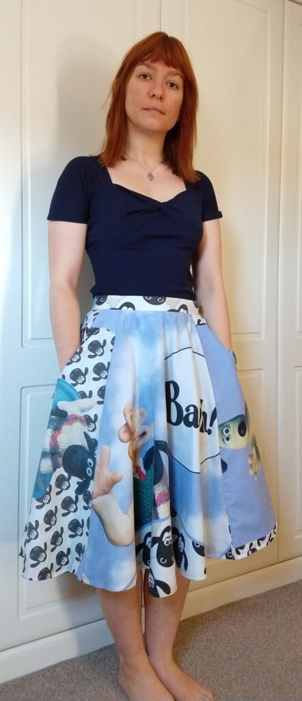 front view of michelle modelling the wallace & gromit skirt with her hands in the pockets