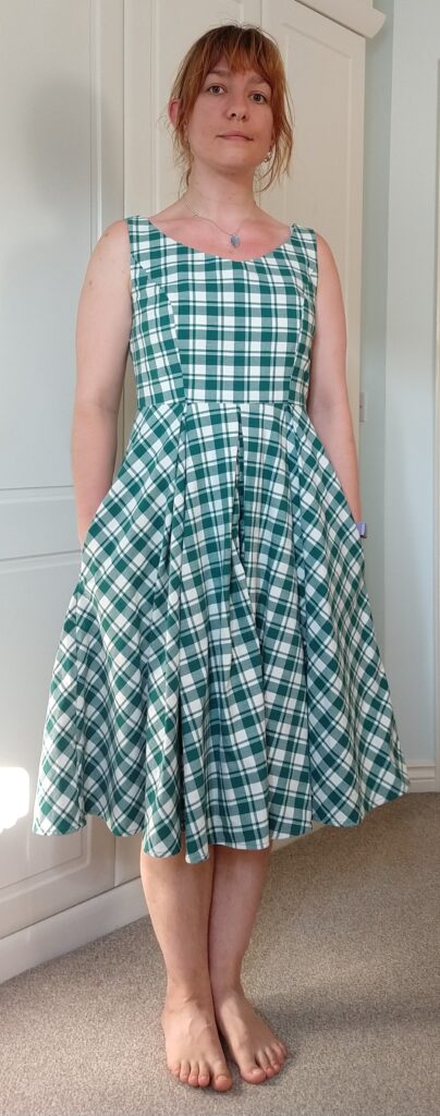 front view of michelle modelling the chequered dress with her hands in the pockets