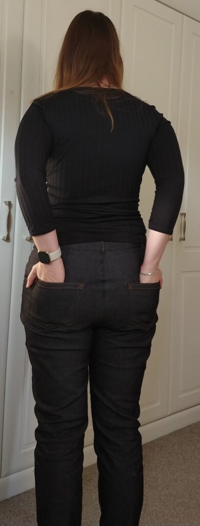 back view of michelle modelling the safran trousers with her hands in the back pockets
